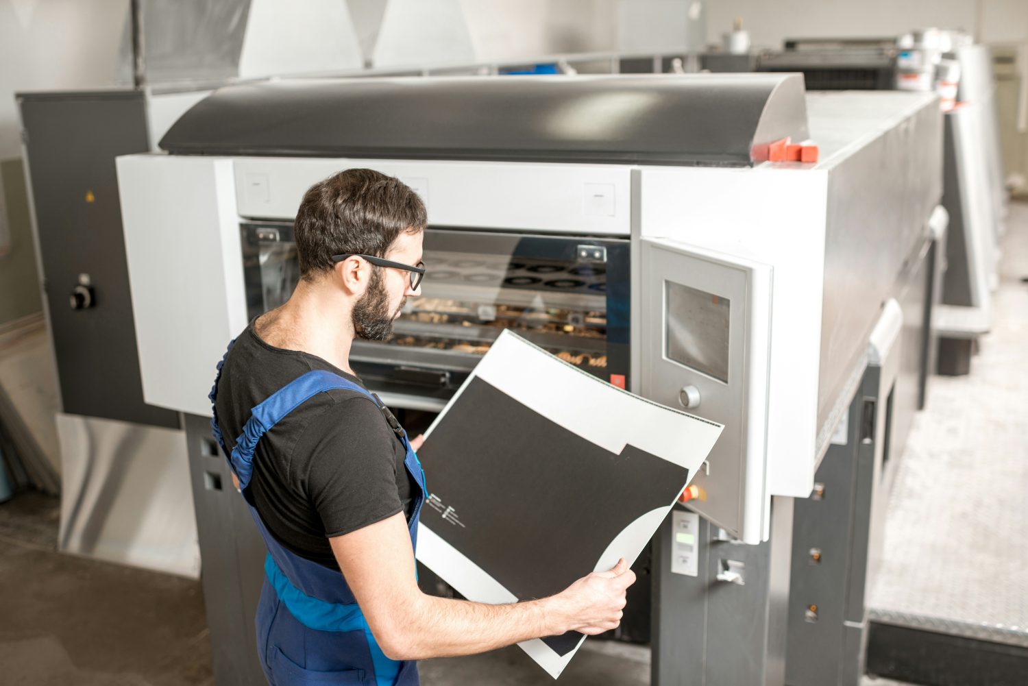 Worker holding a print in a factory